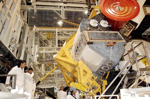 KENNEDY SPACE CENTER, FLA. - In the Orbiter Processing Facility, technicians make final adjustments to the orbital maneuvering system (OMS) pod being installed on Atlantis.   The OMS pod is one of two that are attached to the upper aft fuselage left and right sides. Fabricated primarily of graphite 