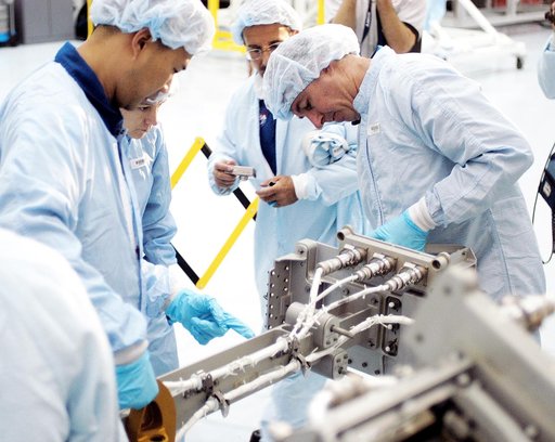 KENNEDY SPACE CENTER, FLA. - In the Space Station Processing Facility, STS-114 crew members get hands-on experience with a Video Stanchion Support Assembly (VSSA).  From left are Mission Specialist Soichi Noguchi, Commander Eileen Collins and Mission Specialists Charles Camarda and Stephen Robinson.