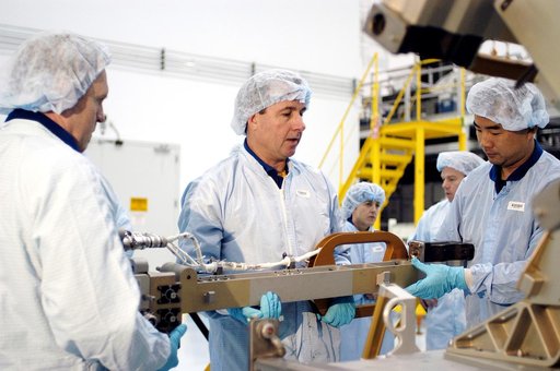 KENNEDY SPACE CENTER, FLA. - In the Space Station Processing Facility, STS-114 crew members get hands-on experience with a Video Stanchion Support Assembly (VSSA).  From left are Mission Specialists Andrew Thomas, Stephen Robinson and Soichi Noguchi, who is with the Japan Aerospace Exploration Agenc