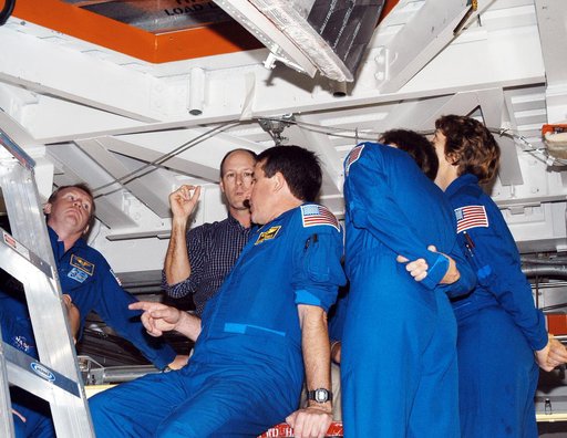 KENNEDY SPACE CENTER, FLA. - In the Orbiter Processing Facility, members of the STS-114 crew look up at the payload bay of orbiter Atlantis.  From left (in flight suits) are Mission Specialists Andrew Thomas, Stephen Robinson and Charles Camarda, and Mission Commander Eileen Collins. The STS-114 cre