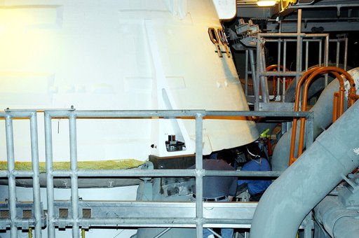 KENNEDY SPACE CENTER, FLA. -  The camera installed on the aft skirt of a solid rocket booster is seen here, framed by the railing.  The installation is in preparation for a vibration test of the Mobile Launcher Platform with SRBs and external tank mounted.  The MLP will roll from one bay to another 