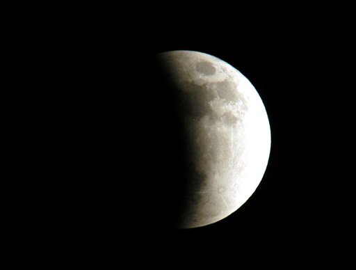 KENNEDY SPACE CENTER, FLA. - The start of a lunar eclipse is viewed from Merritt Island, Fla.  Eclipses occur when the Sun, Earth and Moon line up. They are rare because the Moon usually passes above or below the imaginary line connecting Earth and the Sun. The Earth casts a shadow that the Moon can