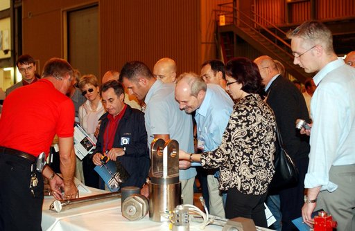 KENNEDY SPACE CENTER, FLA. - Members of the North American Treaty Organization (NATO) Parliamentary Assembly  get a close look at some of the Shuttle’s hardware during their visit to the Vehicle Assembly Building during their tour of KSC. In the background is a segment of a solid rocket booster. The