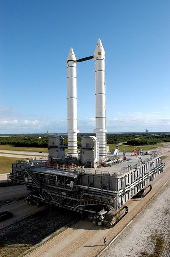 KENNEDY SPACE CENTER, FLA. -  The crawler transporter slowly moves the Mobile Launcher Platform (MLP), carrying a set of twin solid rocket boosters, away from the Vehicle Assembly Building (VAB) in support of engineering analysis vibration tests on the crawler and MLP.  On either side of the booster