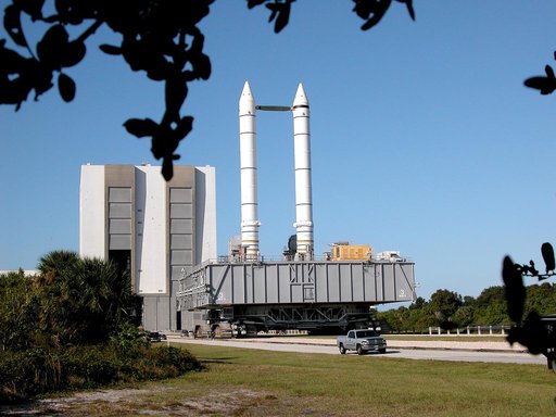 KENNEDY SPACE CENTER, FLA. -  The crawler transporter slowly moves the Mobile Launcher Platform (MLP), carrying a set of twin solid rocket boosters, away from the Vehicle Assembly Building (VAB) in support of engineering analysis vibration tests on the crawler and MLP.   The crawler is moving at var