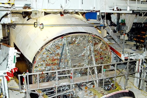 KENNEDY SPACE CENTER, FLA. -  In the Orbiter Processing Facility, United Space Alliance technician Jamie Haynes checks the tiles on the nose of orbiter Atlantis as part of return-to-flight activities.  Atlantis is scheduled for mission STS-114, a return-to-flight test mission to the International Sp