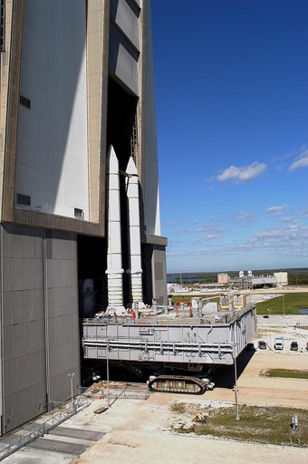 KENNEDY SPACE CENTER, FLA. -  Mobile Launcher Platform (MLP) number 3 and a set of twin solid rocket boosters, atop the crawler-transporter, crawl out of the Vehicle Assembly Building (VAB) in support of the second engineering analysis vibration test on the crawler and MLP. In the background is anot