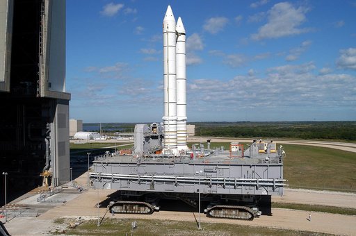 KENNEDY SPACE CENTER, FLA. -  Mobile Launcher Platform (MLP) number 3 and a set of twin solid rocket boosters, atop the crawler-transporter, inch away from the Vehicle Assembly Building (VAB) in support of the second engineering analysis vibration test on the crawler and MLP. The crawler is moving a