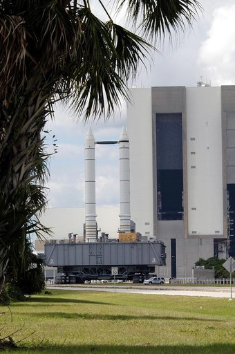 KENNEDY SPACE CENTER, FLA. -  Mobile Launcher Platform (MLP) number 3 and a set of twin solid rocket boosters, atop the crawler-transporter, crawls away from the Vehicle Assembly Building in support of the second engineering analysis vibration test on the crawler and MLP. The crawler is moving at va
