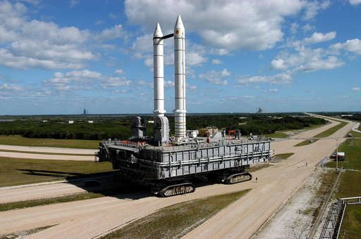 KENNEDY SPACE CENTER, FLA. -  Mobile Launcher Platform (MLP) number 3 and a set of twin solid rocket boosters bolted to it, atop the crawler-transporter, crawl to the intersection in the crawlerway in support of the second engineering analysis vibration test on the crawler and MLP.  In the backgroun