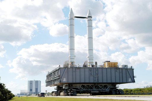 KENNEDY SPACE CENTER, FLA. - The crawler-transporter carrying Mobile Launcher Platform (MLP) number 3, with a set of twin solid rocket boosters bolted atop, crawls to the intersection in the crawlerway in support of the second engineering analysis vibration test on the crawler and MLP.  From this pe