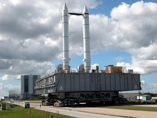 KENNEDY SPACE CENTER, FLA. - A crawler-transporter carrying Mobile Launcher Platform (MLP) number 3, with a set of twin solid rocket boosters bolted atop, crawls to the intersection in the crawlerway in support of the second engineering analysis vibration test on the crawler and MLP.  From this pers