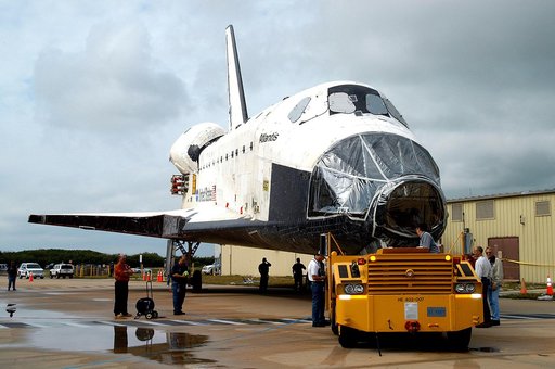 KENNEDY SPACE CENTER, FLA. - The Space Shuttle orbiter Atlantis is towed from the Orbiter Processing Facility (OPF) to the Vehicle Assembly Building (VAB). The move will allow work to be performed in the OPF that can only be accomplished while the bay is empty. Work scheduled in the processing facil