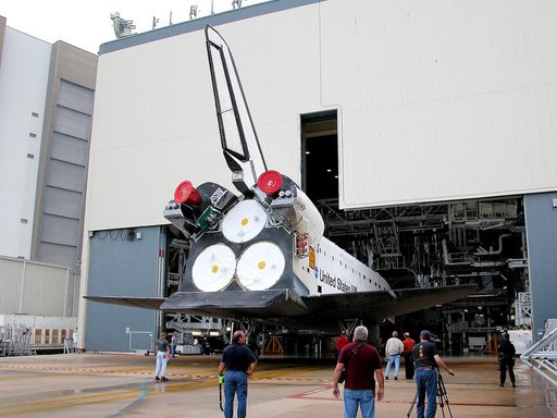 KENNEDY SPACE CENTER, FLA. - The Space Shuttle orbiter Atlantis backs out of the Orbiter Processing Facility (OPF) for its move to the Vehicle Assembly Building (VAB). The move will allow work to be performed in the OPF that can only be accomplished while the bay is empty. Work scheduled in the proc