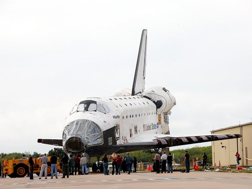 KENNEDY SPACE CENTER, FLA. - Workers walk with Space Shuttle orbiter Atlantis from the Orbiter Processing Facility (OPF) to the Vehicle Assembly Building (VAB) high bay 4. The move will allow work to be performed in the OPF that can only be accomplished while the bay is empty. Work scheduled in the 