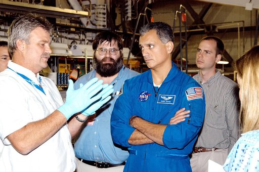 KENNEDY SPACE CENTER, FLA. -  - In the Orbiter Processing Facility astronaut Danny Olivas listens to Greg Grantham (left) talking about the Reinforced Carbon Carbon panels used on the leading edge of the wing of the orbiters.  Behind Olivas are engineers from around the Agency who are working on imp