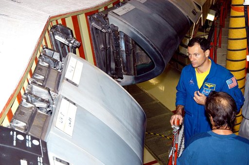 KENNEDY SPACE CENTER, FLA. - In the Orbiter Processing Facility, astronaut Michael E. Lopez-Alegria looks at the Reinforced Carbon Carbon panels used on the leading edge of the wing of the orbiters. He and engineers from around the Agency are on a fact-finding tour for improving the RCC panels used 