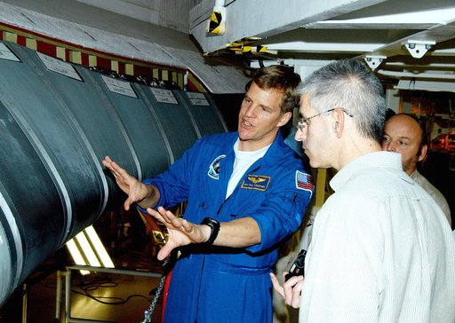 KENNEDY SPACE CENTER, FLA. -  In the Orbiter Processing Facility, astronaut Scott E. Parazynski discusses the Reinforced Carbon Carbon panels used on the leading edge of the wing of the orbiters.  With him are engineers from around the Agency who are working on improving the RCC panels used on the w