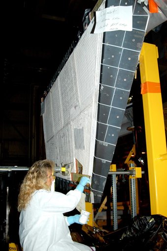 KENNEDY SPACE CENTER, FLA. -  In the Orbiter Processing Facility, KSC employee Nadine Phillips prepares an area on the orbiter Discovery for blanket installation.  The blankets are part of the Orbiter Thermal Protection System, thermal shields to protect against temperatures as high as 3,000° Fahren