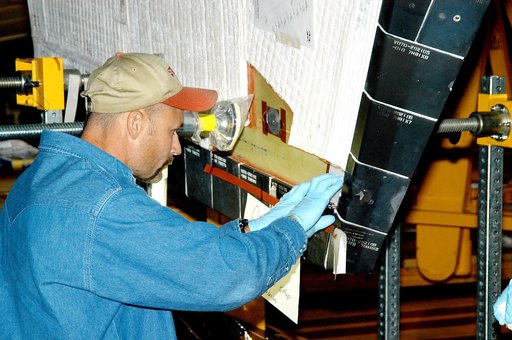 KENNEDY SPACE CENTER, FLA. -  In the Orbiter Processing Facility, KSC employee Joel Smith prepares an area on the orbiter Discovery for blanket installation.  The blankets are part of the Orbiter Thermal Protection System, thermal shields to protect against temperatures as high as 3,000° Fahrenheit,
