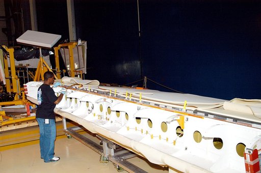 KENNEDY SPACE CENTER, FLA. -  In the Orbiter Processing Facility, KSC employee Duane Williams prepares the blanket insulation to be installed on the body flap on orbiter Discovery.  The blankets are part of the Orbiter Thermal Protection System, thermal shields to protect against temperatures as hig