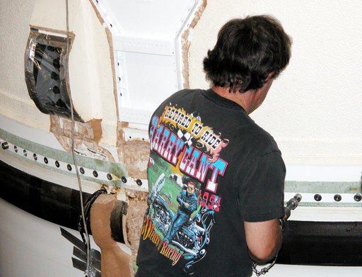 KENNEDY SPACE CENTER, FLA. -  In the Vehicle Assembly Building, a KSC employee loosens a bolt on part of the forward assembly of a solid rocket booster (SRB) before destacking.  The SRB was part of the stack on Atlantis originally scheduled for a March 1, 2003, launch on mission STS-114.  The SRBs a