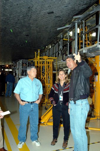 KENNEDY SPACE CENTER, FLA. -- From left, NASA Deputy Associate Administrator for Space Station and Shuttle Programs Michael Kostelnik, United Space Alliance (USA) Director of Orbiter Operations Patty Stratton, and NASA Space Shuttle Program Manager William Parsons view the underside of Shuttle Disco