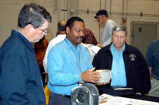 KENNEDY SPACE CENTER, FLA. -- A United Space Alliance (USA) technician (center) discusses aspects of Shuttle processing performed in the Solid Rocket Booster (SRB) Assembly and Refurbishment Facility (ARF) with NASA Deputy Associate Administrator for Space Station and Shuttle Programs Michael Kostel