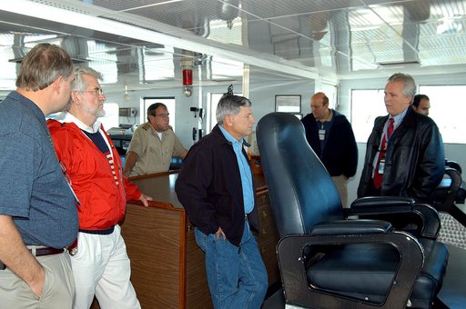 KENNEDY SPACE CENTER, FLA. -- NASA Deputy Associate Administrator for Space Station and Shuttle Programs Michael Kostelnik (center) is given a tour of a solid rocket booster (SRB) retrieval ship by United Space Alliance (USA) employee Joe Chaput (right).  NASA and USA Space Shuttle program managemen