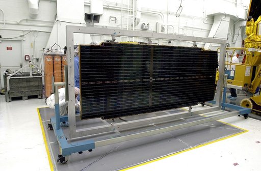 VANDENBERG AFB, CALIF. - Workers in the NASA spacecraft processing facility on North Vandenberg Air Force Base work on a solar array panel to be installed on the Gravity Probe B spacecraft.  Installing each array is a 3-day process and includes a functional deployment test.  The Gravity Probe B miss