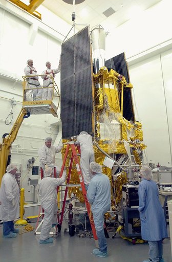 VANDENBERG AFB, CALIF. -  Workers in the NASA spacecraft processing facility on North Vandenberg Air Force Base attach a solar array panel on the Gravity Probe B spacecraft.  Installing each array is a 3-day process and includes a functional deployment test.  The Gravity Probe B mission is a relativ