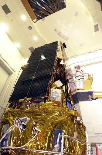 VANDENBERG AFB, CALIF. -  In the NASA spacecraft processing facility on North Vandenberg Air Force Base, a worker checks the installation of a solar array panel onto the Gravity Probe B spacecraft.  Installing each array is a 3-day process and includes a functional deployment test.  The Gravity Prob