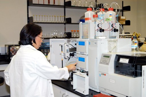 KENNEDY SPACE CENTER, FLA. -- Lanfang Levine, with Dynamac Corp., helps install a Dionex DX-500 IC/HPLC system  in the Space Life Sciences Lab.  The equipment will enable analysis of volatile compounds, such as from plants. The 100,000 square-foot facility houses labs for NASA’s ongoing research eff