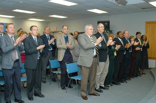 KENNEDY SPACE CENTER, FLA. -- From the KSC television studio, KSC management and other employees applaud President George W. Bush, who addressed the public and an assembly of government officials at NASA Headquarters as he outlined a new focus and vision for the space agency.  Shown from left are Mi
