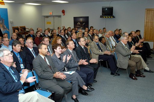 KENNEDY SPACE CENTER, FLA. -- From the KSC television studio, KSC management and other employees applaud President George W. Bush, who addressed the public and an assembly of government officials at NASA Headquarters, outlining a new focus and vision for the space agency.  Fourth from left is Mike L
