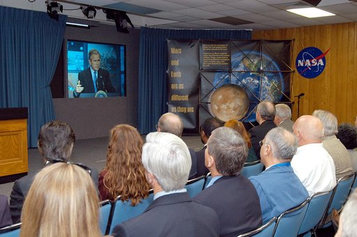 KENNEDY SPACE CENTER, FLA. -- KSC management and other employees gather in the Center’s television studio to watch the address by President George W. Bush from NASA Headquarters stating his goals for NASA’s new mission.  Seated in the front row, left to right, are Ken Aguilar, chief, Equal Opportuni