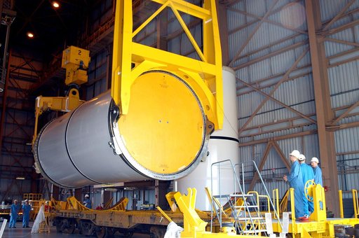 KENNEDY SPACE CENTER, FLA. -  In the Rotation Processing and Surge Facility, an SRB solid segment is lowered onto a rail car for shipment to Utah where it will be tested.  The segment was part of the STS-114 stack.  It is the first time actual flight segments that had been stacked for flight in the 