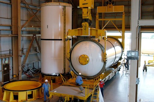 KENNEDY SPACE CENTER, FLA. -  In the Rotation Processing and Surge Facility, an SRB solid segment is lowered onto a rail car for shipment to Utah where it will be tested.  The segment was part of the STS-114 stack.  It is the first time actual flight segments that had been stacked for flight in the 