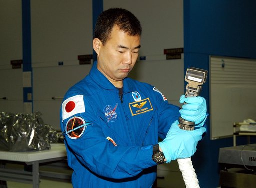 KENNEDY SPACE CENTER, FLA. -  STS-114 Mission Specialist Soichi Noguchi, with the Japanese Aerospace Exploration Agency (JAXA), handles equipment that will be used on the mission.  He and other crew members are at KSC for equipment familiarization.  STS-114 is classified as Logistics Flight 1 to the