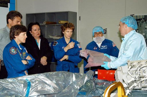 KENNEDY SPACE CENTER, FLA. -  STS-114 Mission Specialist Andrew Thomas (right) shows some of the mission equipment to other crew members (from left) Wendy Lawrence, mission specialist; Eileen Collins, commander; and Charles Camarda, mission specialist.  Crew members are at KSC for equipment familiar