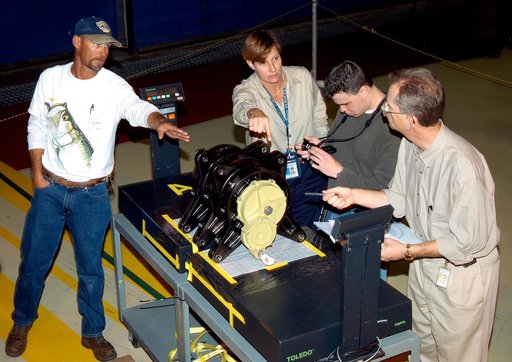 KENNEDY SPACE CENTER, FLA. -   Workers in the Orbiter Processing Facility measure the alignment of bearings on a rudder speed brake actuator.  Actuators move an orbiter’s rudder, speed brake, elevons and main engines during flight.