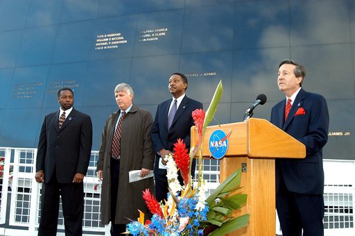 KENNEDY SPACE CENTER, FLA. -  At the podium in front of the Space Memorial Mirror at the KSC Visitor Complex is Dr. Stephen Feldman, president of the Astronaut Memorial Foundation.  He spoke to attendees at the memorial service remembering and honoring the crew of Columbia.  With him (from left) are
