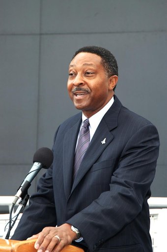 KENNEDY SPACE CENTER, FLA. -  Winston Scott, executive director of Florida Space Authority, speaks to attendees at a memorial service honoring the crew of Columbia.  He stands in front of the Space Memorial Mirror at the KSC Visitor Complex.  Feb. 1 is the one-year anniversary of the loss of the cre