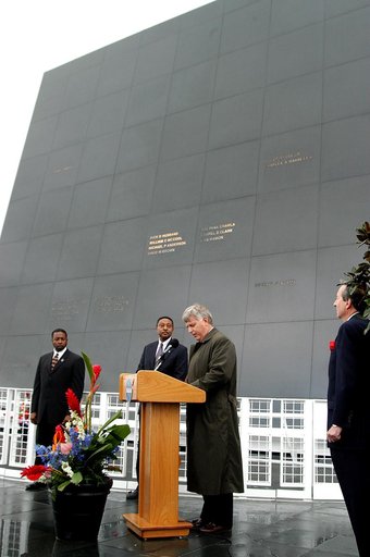 KENNEDY SPACE CENTER, FLA. -  In front of the Space Memorial Mirror at the KSC Visitor Complex, Center Director Jim Kennedy (right) speaks to visitors gathered for the memorial service honoring the crew of Columbia.   At left are KSC Deputy Director Woodrow Whitlow Jr. and Executive Director of Flor