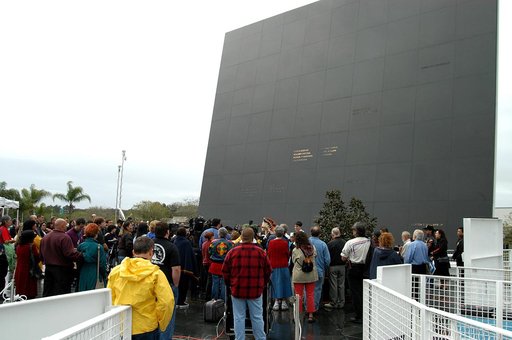 KENNEDY SPACE CENTER, FLA. - At the Space Memorial Mirror in the KSC Visitor Complex, visitors gather around dancers from the Shoshone-Bannock Native American community, Fort Hall, Idaho, who are performing a healing ceremony during the memorial service held for the crew of Columbia.  Feb. 1 is the 