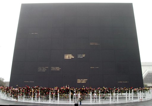 KENNEDY SPACE CENTER, FLA. - Roses and other flowers ring the base of the Astronaut Memorial Mirror at the KSC Visitor Complex following a memorial service held for the crew of Columbia on the anniversary of the tragic accident that took their lives Feb. 1, 2003.  The public was invited to the servi