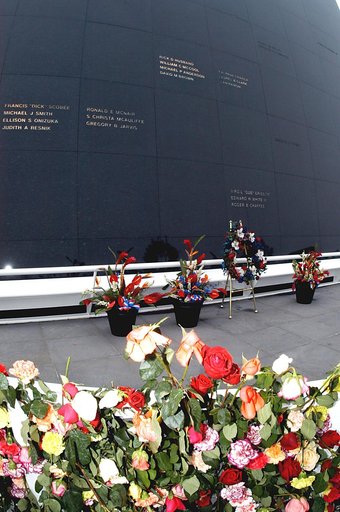 KENNEDY SPACE CENTER, FLA. - A wreath and other floral arrangements rest beneath the Astronaut Memorial Mirror at the KSC Visitor Complex following a memorial service held for the crew of Columbia on the anniversary of the tragic accident that took their lives Feb. 1, 2003.  In the foreground are a 