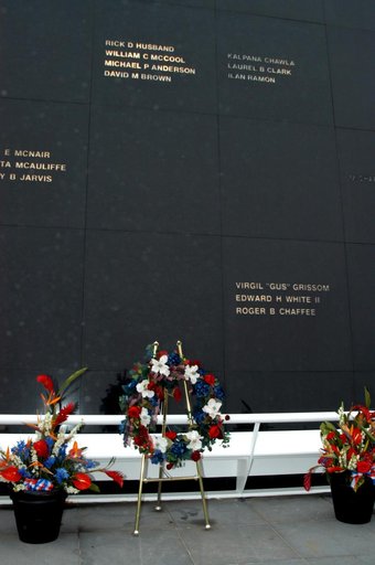 KENNEDY SPACE CENTER, FLA. - A wreath and other floral arrangements rest beneath the Astronaut Memorial Mirror at the KSC Visitor Complex following a memorial service held for the crew of Columbia on the anniversary of the tragic accident that took their lives Feb. 1, 2003. The black granite mirror 