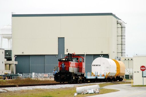 KENNEDY SPACE CENTER, FLA. - The red NASA engine backs up with its cargo of containers in order to change tracks.  The containers enclose segments of a solid rocket booster being returned to Utah for testing.  The segments were part of the STS-114 stack.  It is the first time actual flight segments 