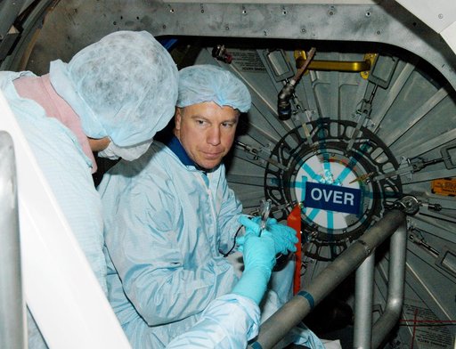 KENNEDY SPACE CENTER, FLA. - Astronaut Tim Kopra (facing camera) aids in Intravehicular Activity (IVA) constraints testing on the Italian-built Node 2, a future element of the International Space Station.  The second of three Station connecting modules, the Node 2 attaches to the end of the U.S. Lab